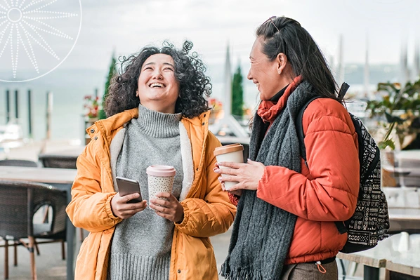 two women chatting over coffee